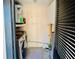 Functional laundry room featuring modern washer/dryer units, shelving, and storage for household needs at 14736 Norwood Oaks Dr # 103, Tampa, FL 33613