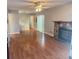 Bright living room with laminate floors, fan, natural light, and a cozy stone fireplace at 14736 Norwood Oaks Dr # 103, Tampa, FL 33613