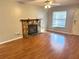 Inviting living room with a stone fireplace, laminate flooring, ceiling fan, and lots of natural light at 14736 Norwood Oaks Dr # 103, Tampa, FL 33613