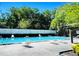 Outdoor pool with lounge chairs, and a fence at 14736 Norwood Oaks Dr # 103, Tampa, FL 33613