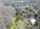 Scenic aerial view of a home nestled amidst lush greenery, nearby lake, and surrounded by a serene neighborhood setting at 14821 Sassandra Dr, Odessa, FL 33556