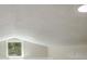 Attic featuring a window at 14821 Sassandra Dr, Odessa, FL 33556