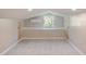 Attic featuring two doors, a window and an air conditioner at 14821 Sassandra Dr, Odessa, FL 33556