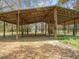 Large open barn structure with wooden beams, metal roof, and plenty of space for storage or activities at 14821 Sassandra Dr, Odessa, FL 33556