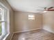 Light filled bedroom with light wood floors, neutral walls and large windows at 14821 Sassandra Dr, Odessa, FL 33556