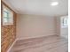 Bedroom featuring a stylish brick accent wall, neutral paint, and ample natural light, creating a cozy atmosphere at 14821 Sassandra Dr, Odessa, FL 33556