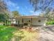Well-maintained single-story home featuring a covered carport, brick facade, and manicured landscaping for a welcoming appeal at 14821 Sassandra Dr, Odessa, FL 33556
