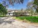 Inviting single-story home with a covered entrance and well-maintained landscaping for enhanced curb appeal and charm at 14821 Sassandra Dr, Odessa, FL 33556