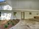 Covered entrance showcasing a welcoming front door, landscaped garden, and an inviting curb appeal for the charming home at 14821 Sassandra Dr, Odessa, FL 33556