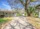 House exterior showing the long driveway and the exterior of the house at 14821 Sassandra Dr, Odessa, FL 33556