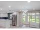 Bright, spacious kitchen featuring stainless steel appliances, white cabinetry, and an island with elegant marble countertops at 14821 Sassandra Dr, Odessa, FL 33556