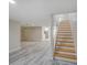 Bright living room featuring hardwood floors, recessed lighting, and staircase leading to upper level at 14821 Sassandra Dr, Odessa, FL 33556