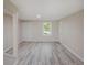 Inviting living room featuring hardwood flooring, neutral walls, and abundant natural light through large windows at 14821 Sassandra Dr, Odessa, FL 33556
