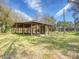 A large open-air outbuilding surrounded by lush greenery, ideal for outdoor storage at 14821 Sassandra Dr, Odessa, FL 33556