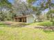 Metal storage shed with open sides in a grassy area on the property at 14821 Sassandra Dr, Odessa, FL 33556