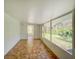 Bright sunroom with windows along the walls and light tile flooring at 14821 Sassandra Dr, Odessa, FL 33556