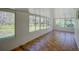 Enclosed sunroom with wall-to-wall windows and tile flooring at 14821 Sassandra Dr, Odessa, FL 33556