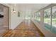 Bright sunroom featuring tile flooring, large windows, and access to the outdoor views at 14821 Sassandra Dr, Odessa, FL 33556