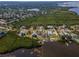 Overhead view of waterfront community surrounded by lush greenery and winding waterways at 1616 Sea Breeze Dr, Tarpon Springs, FL 34689