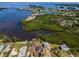 Scenic aerial view of waterfront homes nestled around a tranquil lagoon at 1616 Sea Breeze Dr, Tarpon Springs, FL 34689