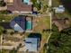 Aerial shot of a home with a screened-in pool, boat dock and lush landscaping at 1616 Sea Breeze Dr, Tarpon Springs, FL 34689