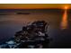 Stunning aerial view of waterfront homes on peninsula with breathtaking sunset over the water, highlighting the coastal living experience at 1616 Sea Breeze Dr, Tarpon Springs, FL 34689