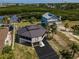Aerial view of property showcasing waterfront access, lush greenery, and distinct architecture at 1616 Sea Breeze Dr, Tarpon Springs, FL 34689