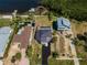 Aerial view of waterfront homes showcasing pool, lush landscaping, and dock access to the water at 1616 Sea Breeze Dr, Tarpon Springs, FL 34689