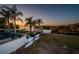 Expansive backyard featuring multiple kayaks, a dock, waterfront access, and lush landscaping providing the perfect outdoor getaway at 1616 Sea Breeze Dr, Tarpon Springs, FL 34689