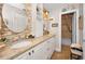Bright bathroom featuring double sinks with granite countertops and modern fixtures at 1616 Sea Breeze Dr, Tarpon Springs, FL 34689