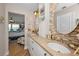 Bathroom featuring double sinks with granite countertops, tile backsplash, and travertine floors at 1616 Sea Breeze Dr, Tarpon Springs, FL 34689