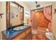 Unique bathroom design with decorative mirror, tile flooring and a bathtub with shower at 1616 Sea Breeze Dr, Tarpon Springs, FL 34689