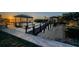 Waterfront dock featuring boat lifts, scenic views, and serene waterways at sunset at 1616 Sea Breeze Dr, Tarpon Springs, FL 34689