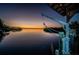 Picturesque waterfront dock featuring a boat lift, and stunning sunset views at 1616 Sea Breeze Dr, Tarpon Springs, FL 34689