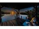 Inviting waterfront home featuring a covered boat dock with lift and picturesque sunset views at 1616 Sea Breeze Dr, Tarpon Springs, FL 34689