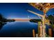 Picturesque waterfront dock featuring a boat lift, and stunning sunset views at 1616 Sea Breeze Dr, Tarpon Springs, FL 34689