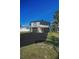 Two-story house featuring covered parking, screened in porch, and a paved driveway at 1616 Sea Breeze Dr, Tarpon Springs, FL 34689