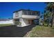 Charming two-story home with a lovely front yard and a screened-in patio area at 1616 Sea Breeze Dr, Tarpon Springs, FL 34689