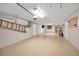 Spacious garage with painted floor and walls and fluorescent lighting providing an excellent workspace at 1616 Sea Breeze Dr, Tarpon Springs, FL 34689