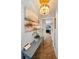 Charming hallway featuring elegant lighting, wainscoting, and decorative artwork at 1616 Sea Breeze Dr, Tarpon Springs, FL 34689