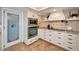 Well-equipped kitchen with custom cabinetry, granite countertops, stainless steel appliances, and a wine cellar at 1616 Sea Breeze Dr, Tarpon Springs, FL 34689