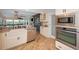 Spacious kitchen featuring stainless appliances, granite countertops, and a wine cellar at 1616 Sea Breeze Dr, Tarpon Springs, FL 34689