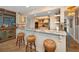 Open concept kitchen with granite counters, stainless appliances, and barstool seating at 1616 Sea Breeze Dr, Tarpon Springs, FL 34689
