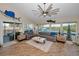 Spacious living room with high ceilings, modern fan, coastal decor, and views of the intercoastal at 1616 Sea Breeze Dr, Tarpon Springs, FL 34689