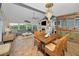 Spacious living room with views of kitchen and outdoor waterfront featuring coastal decor and hardwood floors at 1616 Sea Breeze Dr, Tarpon Springs, FL 34689