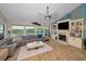 Spacious living room with a fireplace, large windows and beautiful waterfront views at 1616 Sea Breeze Dr, Tarpon Springs, FL 34689