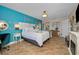 Spacious main bedroom features a white fireplace, water views, and turquoise walls and decor at 1616 Sea Breeze Dr, Tarpon Springs, FL 34689