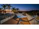 Relax on this cozy deck with a hammock overlooking the water and swaying palm trees at 1616 Sea Breeze Dr, Tarpon Springs, FL 34689