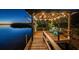 Enjoy waterfront dining at dusk on the covered boat dock, complete with seating and ambient lighting at 1616 Sea Breeze Dr, Tarpon Springs, FL 34689