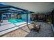 Backyard featuring a large screened-in pool and patio area, perfect for outdoor relaxation and entertainment at 1616 Sea Breeze Dr, Tarpon Springs, FL 34689